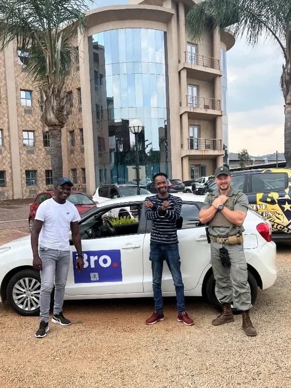 Bro team and security partner standing with arms crossed in front of a Bro-branded vehicle in Johannesburg
