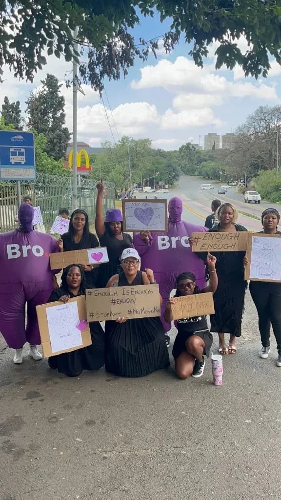Women and Bro mascots standing together with anti-GBV signs in Johannesburg