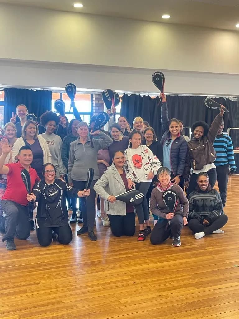 Women holding self-defence striking pads at the Defence Unlimited workshop