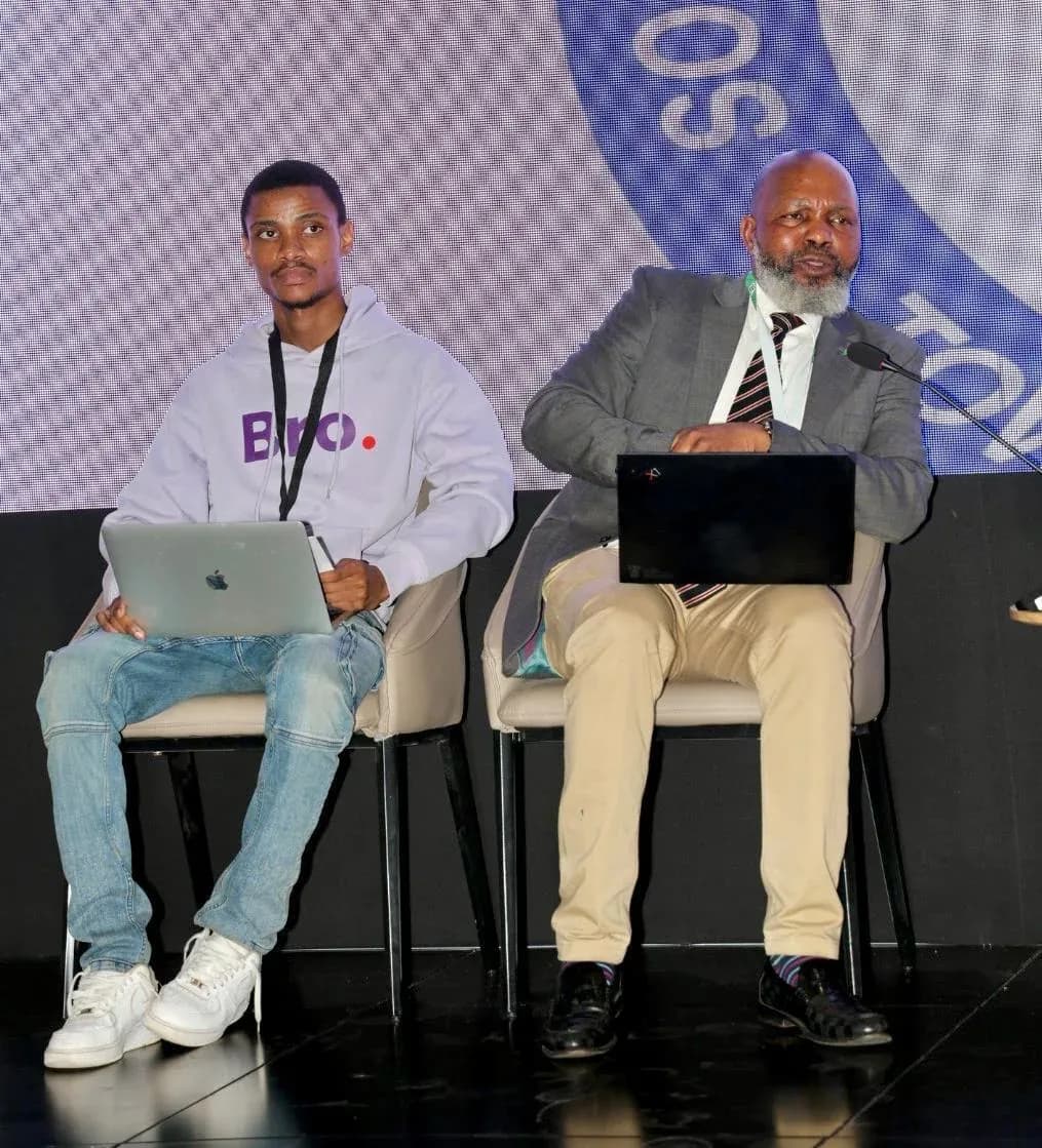 Bro Cabs Co-founder and COO Msizi in a Bro hoodie seated beside a fellow panellist during a session at SADC Industrialisation Week
